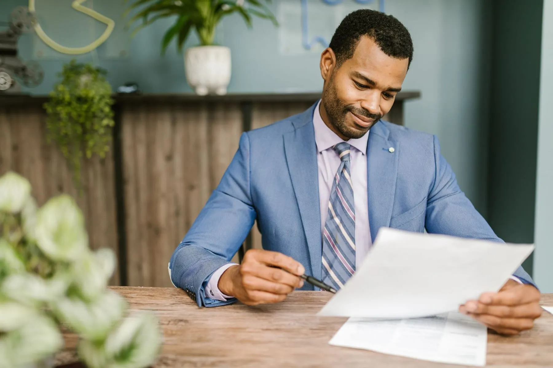 A producer reading through an application at their desk
