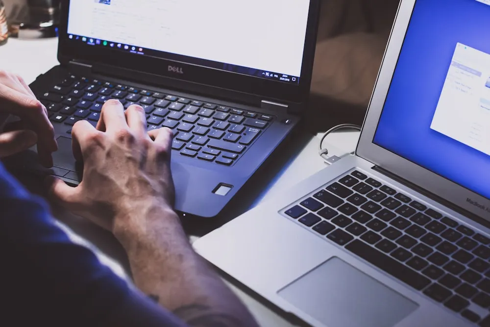 Hands working at a laptop showing site analytics