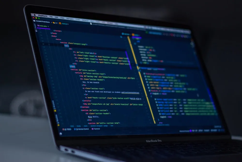 A laptop displaying application code