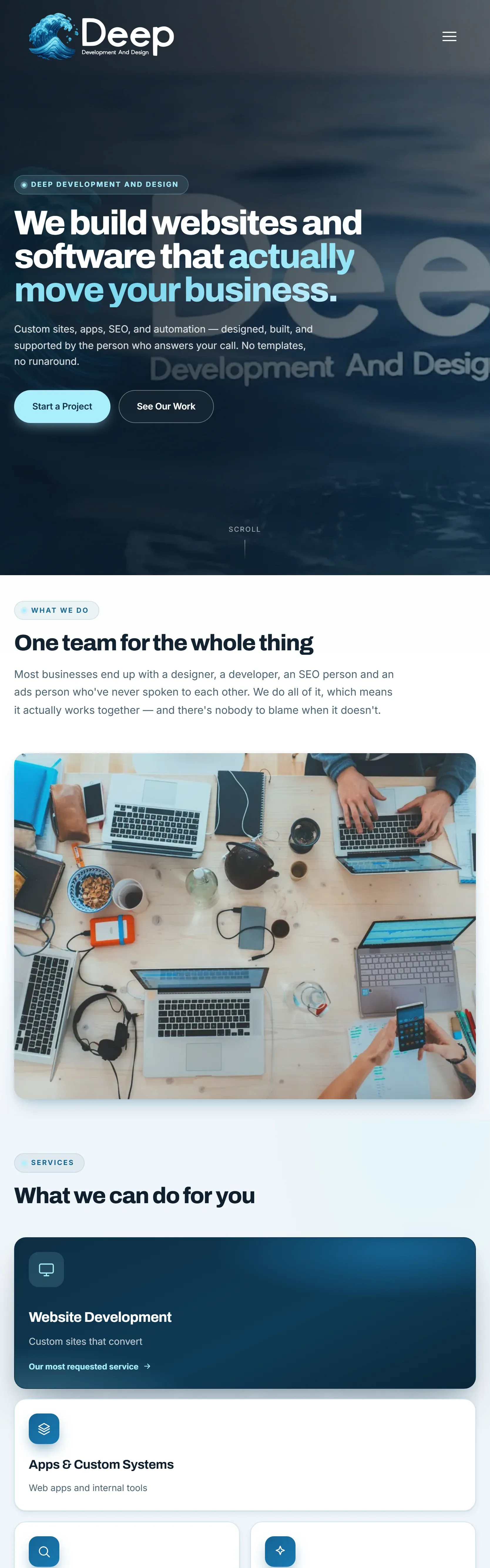 The Deep Development and Design home page on a tablet, the navy hero headline and call-to-action buttons above a photograph of a shared desk covered in laptops and notebooks