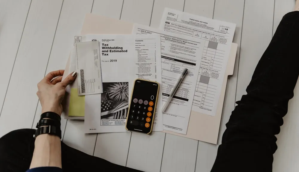 Paperwork and a calculator laid out on a desk