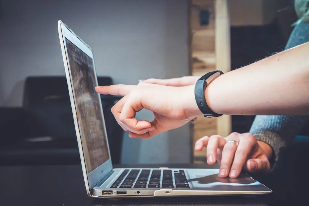 Two people working through something on a laptop together