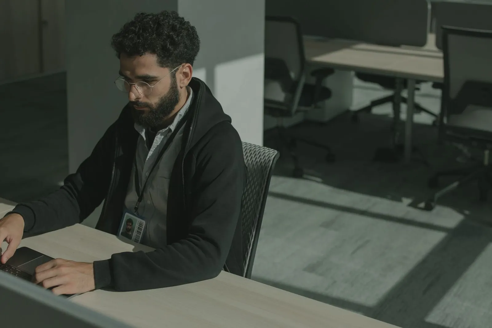 One person working alone at a desk in a quiet office