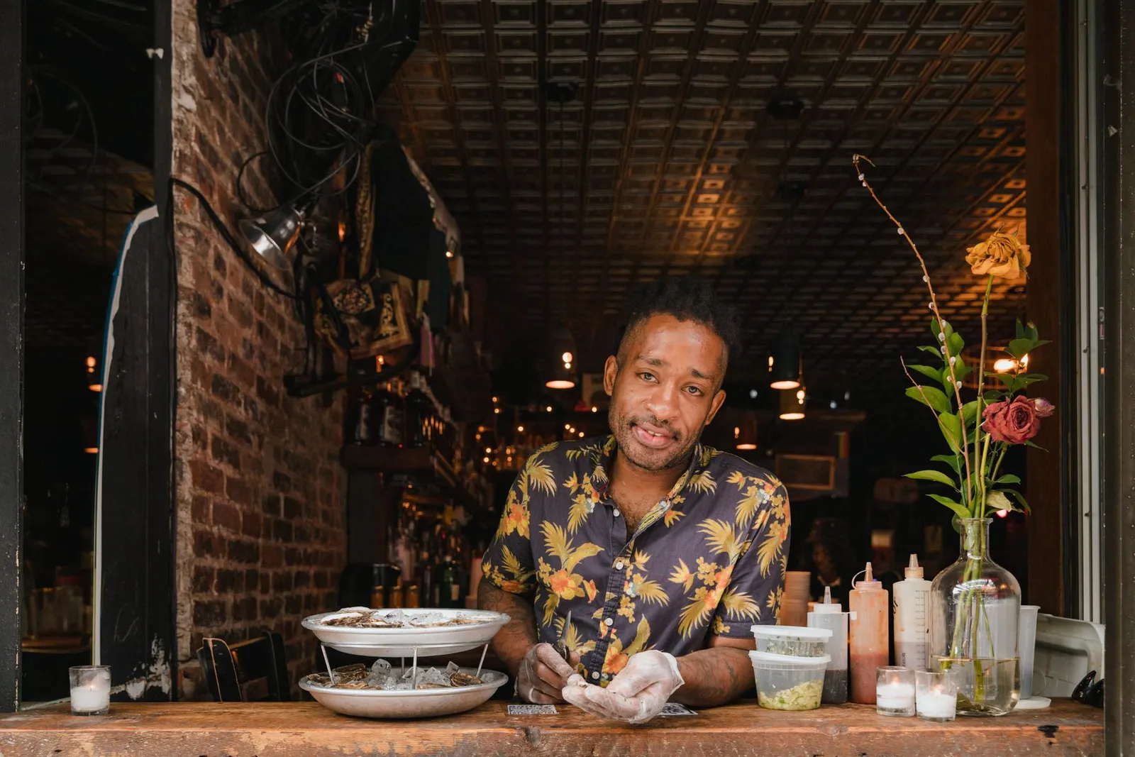 A chef preparing food behind a restaurant counter